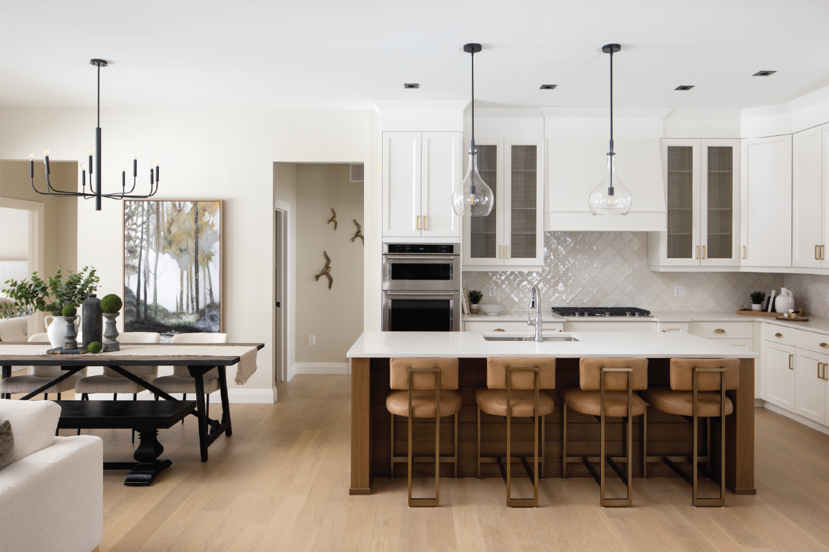 Forest Trail model home kitchen featuring mixed metals, gold hardware, black pendant lights, and Zellige tile backsplash.