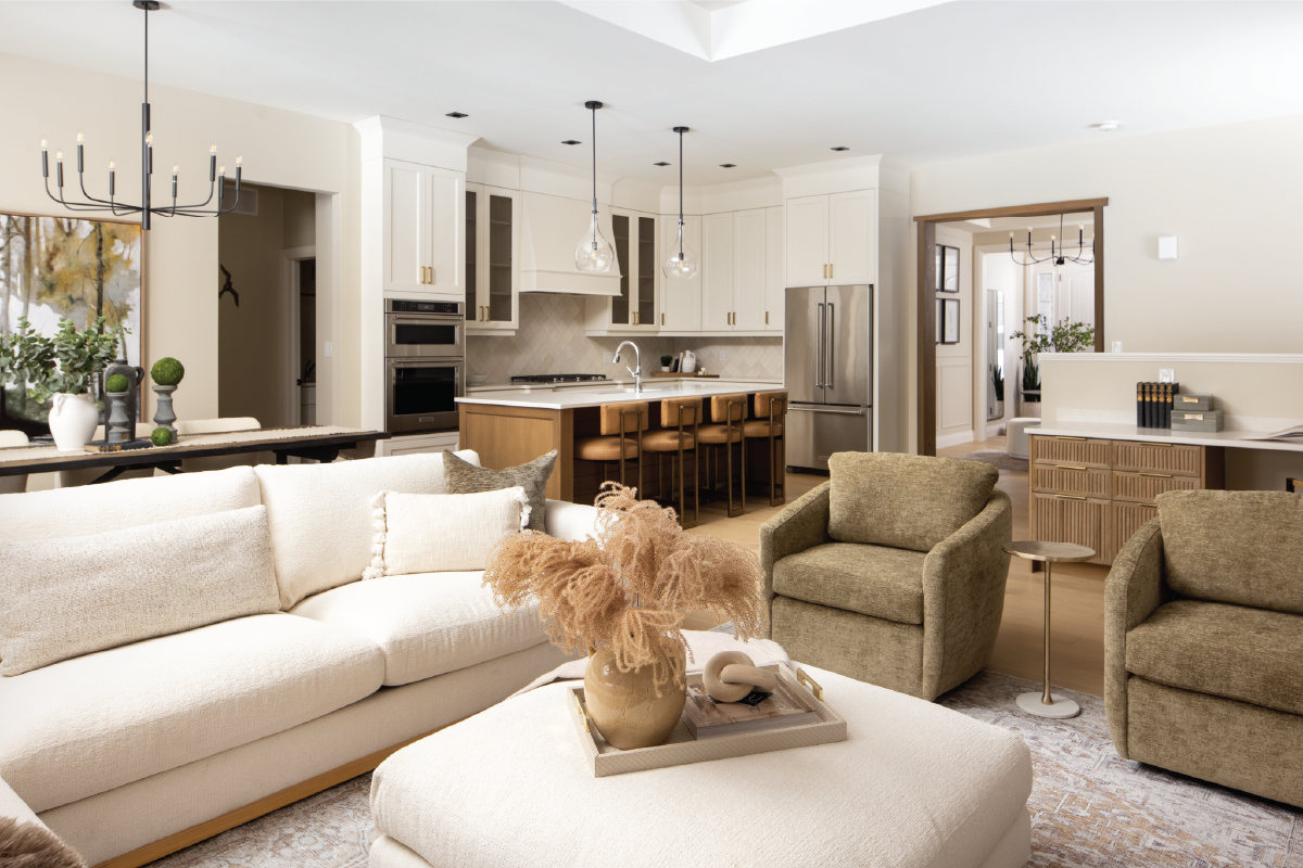 Open-concept living room and kitchen at Forest Trail model home featuring neutral textures, wood accents, and layered modern design.